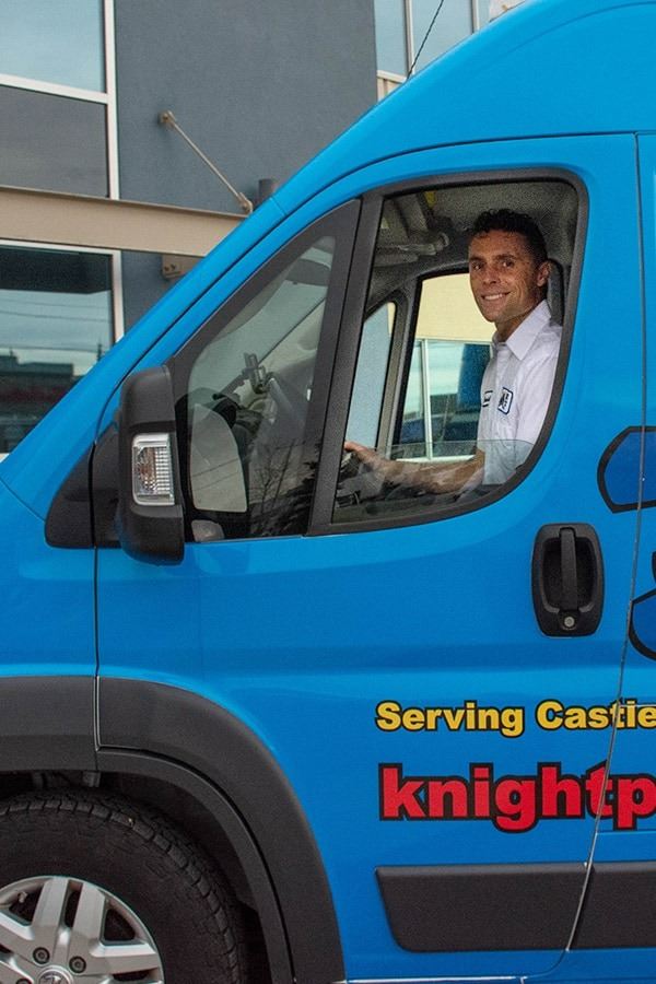 technician sitting in Knight Plumbing, Heating & Air Conditioning van