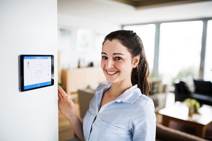 Woman-with-smart-tablet-thermostat